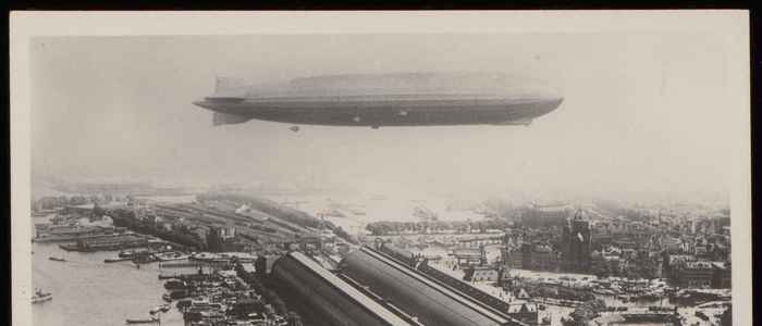 1924 Graf Zeppelin hangt boven het Centraal Station van Amsterdam, luchtfoto KLM